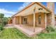 Covered back patio with brick accents and door to the backyard at 2180 S Flower Way, Lakewood, CO 80227