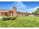 Brick home exterior and covered back patio overlooking the spacious backyard at 2180 S Flower Way, Lakewood, CO 80227