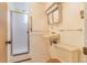 Bathroom featuring a standing shower, sink, medicine cabinet, and toilet at 2180 S Flower Way, Lakewood, CO 80227