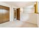 Cozy bedroom features a closet, mirror, neutral carpet, and natural light at 2180 S Flower Way, Lakewood, CO 80227