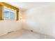 Bright bedroom with window, neutral carpet, and vintage light fixture at 2180 S Flower Way, Lakewood, CO 80227
