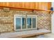 Close up of brick fireplace with glass doors, wood mantel, and hearth at 2180 S Flower Way, Lakewood, CO 80227