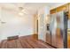 Eat-in kitchen with stainless steel refrigerator and wood laminate flooring at 2180 S Flower Way, Lakewood, CO 80227