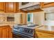 Kitchen counter with electric range, oven and tile backsplash and ample cabinetry at 2180 S Flower Way, Lakewood, CO 80227