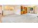 Bright living room features neutral walls and carpets, and a partial view of the kitchen at 2180 S Flower Way, Lakewood, CO 80227