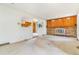 Spacious living room featuring a brick fireplace, wood paneling, and arched entryway at 2180 S Flower Way, Lakewood, CO 80227