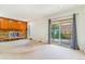Bright living room with brick fireplace and sliding glass doors to backyard at 2180 S Flower Way, Lakewood, CO 80227