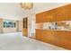 Spacious living room area with a view into kitchen featuring wood cabinets at 2180 S Flower Way, Lakewood, CO 80227