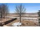 Wide backyard with an expanse of land, a wooden fence and seasonal snow at 1624 Westin Dr, Erie, CO 80516