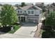 Aerial view of a two-story home with well-manicured front and back lawns in a suburban neighborhood at 2198 Broadleaf Loop, Castle Rock, CO 80109