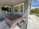 This covered back patio features a hot tub, concrete flooring and a view of the backyard and perimeter fence at 2198 Broadleaf Loop, Castle Rock, CO 80109