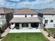 Aerial view of a backyard featuring a covered patio and lush green lawn at 2198 Broadleaf Loop, Castle Rock, CO 80109