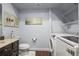 Bathroom featuring a dark vanity with white walls and a laundry area at 2198 Broadleaf Loop, Castle Rock, CO 80109