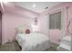 A bedroom with pink walls, a ceiling fan, and a comfortable looking bed at 2198 Broadleaf Loop, Castle Rock, CO 80109
