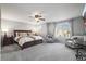 Spacious carpeted bedroom with large window, ceiling fan, and elegant furnishings in neutral tones at 2198 Broadleaf Loop, Castle Rock, CO 80109
