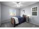 Cozy bedroom with two windows, a ceiling fan, and neutral gray paint at 2198 Broadleaf Loop, Castle Rock, CO 80109