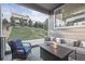 Covered patio with a cozy seating area, fire pit, and view of the landscaped backyard at 2198 Broadleaf Loop, Castle Rock, CO 80109