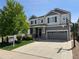 Charming two-story home features a well-manicured lawn and a welcoming front porch at 2198 Broadleaf Loop, Castle Rock, CO 80109