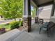 Inviting front porch with stone pillars and seating, perfect for relaxing outdoors at 2198 Broadleaf Loop, Castle Rock, CO 80109