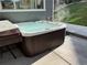 Inviting hot tub on a concrete patio surrounded by a grass yard and a perimeter fence, ready for relaxation at 2198 Broadleaf Loop, Castle Rock, CO 80109
