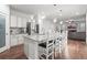 Bright, modern kitchen boasts a granite island with seating and stainless steel appliances at 2198 Broadleaf Loop, Castle Rock, CO 80109
