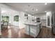 Bright kitchen and breakfast nook with white cabinetry, granite countertops, and hardwood floors at 2198 Broadleaf Loop, Castle Rock, CO 80109