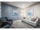 Well-lit living room with a white sofa, patterned armchairs, and neutral decor at 2198 Broadleaf Loop, Castle Rock, CO 80109