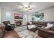 Spacious living room with a stone fireplace, large TV, and comfortable leather furniture at 2198 Broadleaf Loop, Castle Rock, CO 80109