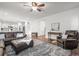 Open concept living room with hardwood floors, a leather sectional, and a view into the kitchen at 2198 Broadleaf Loop, Castle Rock, CO 80109