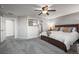 Bright, carpeted main bedroom boasts a king bed, ceiling fan, and ensuite bathroom for a relaxing retreat at 2198 Broadleaf Loop, Castle Rock, CO 80109