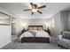 This main bedroom features a king bed, ceiling fan, ensuite bathroom with a glass door shower and neutral colors at 2198 Broadleaf Loop, Castle Rock, CO 80109