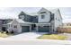 Charming home featuring two garage doors, gray color scheme, and well-maintained landscaping at 14247 Beebalm Loop, Parker, CO 80134
