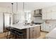 Spacious kitchen features a large island with seating, stainless steel appliances, and sleek pendant lighting at 14247 Beebalm Loop, Parker, CO 80134