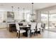 Bright, modern kitchen with white cabinets, stainless steel appliances, and a kitchen island at 14247 Beebalm Loop, Parker, CO 80134