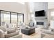 Bright living room featuring a fireplace with tile accent wall, large window, and comfortable seating at 14247 Beebalm Loop, Parker, CO 80134