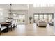 Bright living room with hardwood floors and large windows that enhance the open floor plan at 14247 Beebalm Loop, Parker, CO 80134
