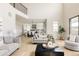 Open concept living area with hardwood floors and views into the kitchen and dining areas at 14247 Beebalm Loop, Parker, CO 80134
