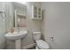 Small bathroom with pedestal sink and toilet at 12255 Hazel Spruce Ct, Parker, CO 80134