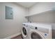 Convenient laundry room with washer, dryer, and shelving at 12255 Hazel Spruce Ct, Parker, CO 80134