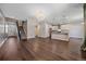 Bright living room featuring hardwood floors, staircase, and open access to a modern kitchen at 12255 Hazel Spruce Ct, Parker, CO 80134