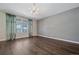 Bright living room with hardwood floors and large window at 12255 Hazel Spruce Ct, Parker, CO 80134
