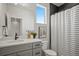 Neutral bathroom design offers modern comfort with its shower, vanity with ample counter space, and natural light from a window at 16637 Shoshone St, Broomfield, CO 80023