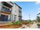 A modern townhome featuring a balcony, wood accents, and landscaping at 16637 Shoshone St, Broomfield, CO 80023