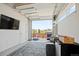 Spacious garage with a sectional couch, TV, a BBQ and a full view of the yard creates a stylish, multipurpose space at 16637 Shoshone St, Broomfield, CO 80023