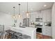 Modern eat-in kitchen with stainless steel appliances, an island with seating, and pendant lighting at 16637 Shoshone St, Broomfield, CO 80023