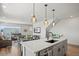 Bright kitchen with a large island, modern pendant lighting, and an open floor plan at 16637 Shoshone St, Broomfield, CO 80023