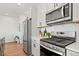 Modern kitchen features stainless steel appliances, white cabinets, and a stylish backsplash at 16637 Shoshone St, Broomfield, CO 80023