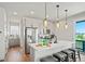 A modern, eat-in kitchen with stainless steel appliances and an island with bar stool seating at 16637 Shoshone St, Broomfield, CO 80023