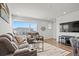 Comfortable living room featuring modern decor, plush seating, and large windows at 16637 Shoshone St, Broomfield, CO 80023