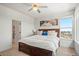 Bright main bedroom with ceiling fan, double bed, and neighborhood views from a sunny window provide comfort and style at 16637 Shoshone St, Broomfield, CO 80023